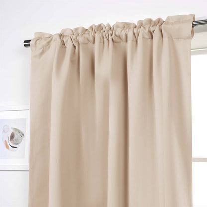 Beige curtain hanging on a rod against a white wall