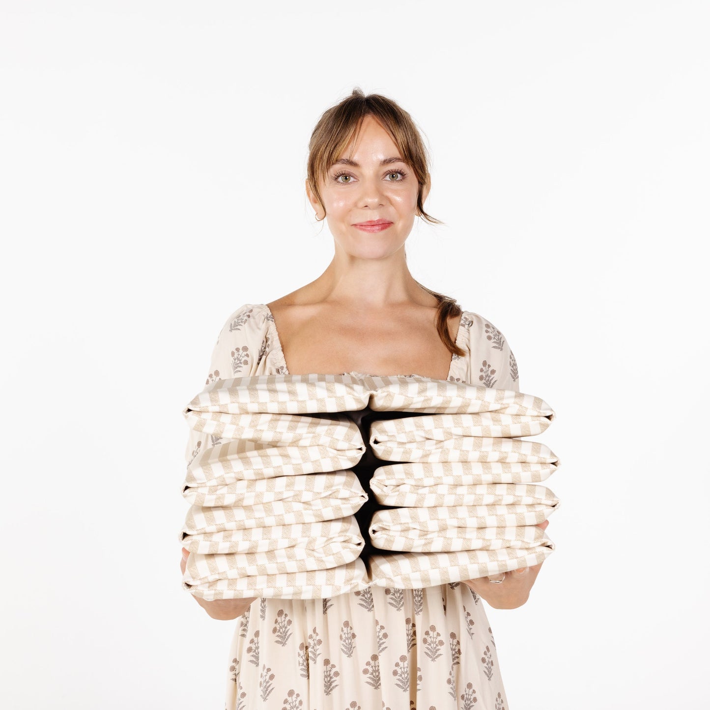 Woman wrapped in a folded child ball pit on a white background