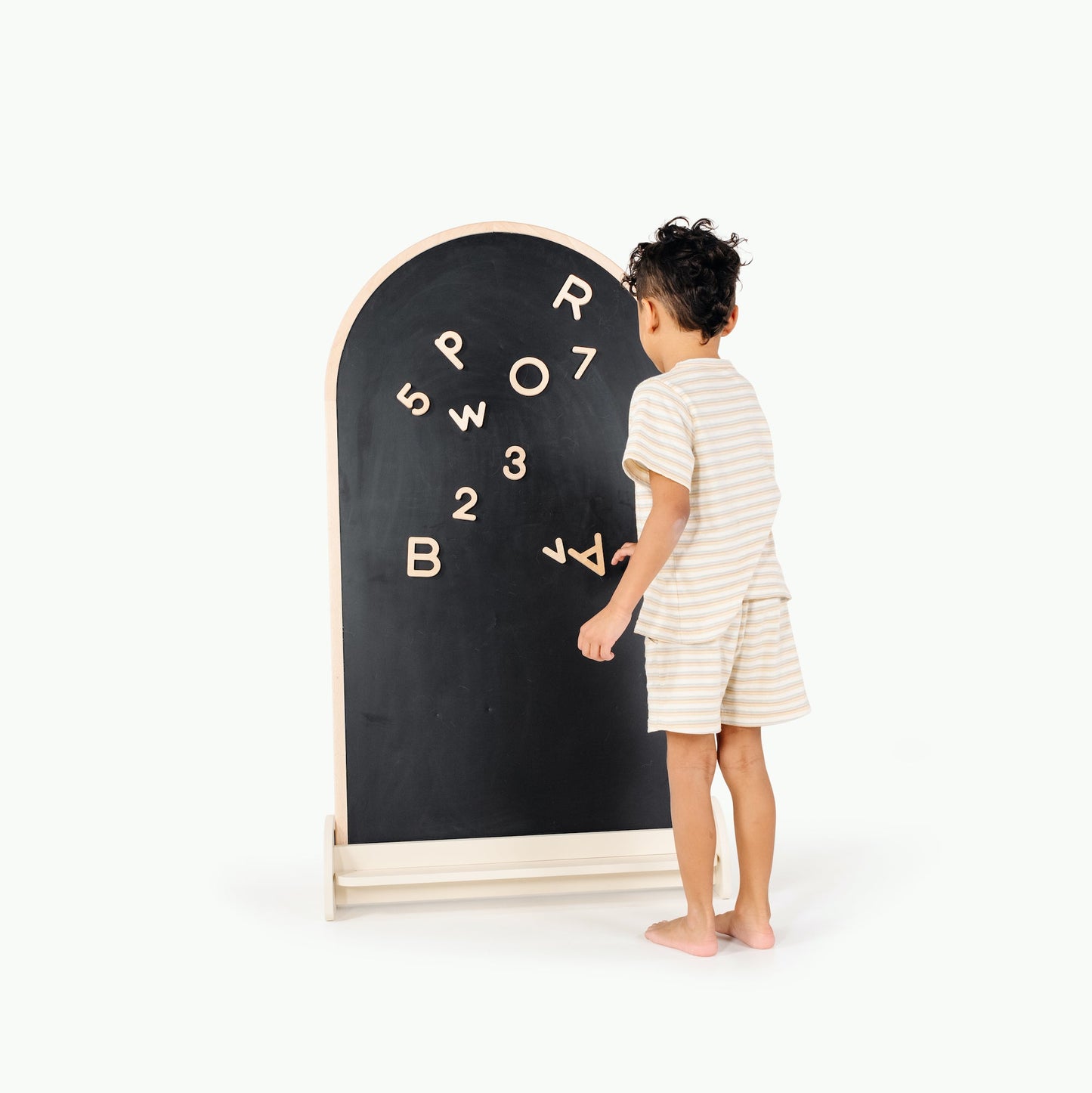 Child interacting with a blackboard with letters and numbers on a white background