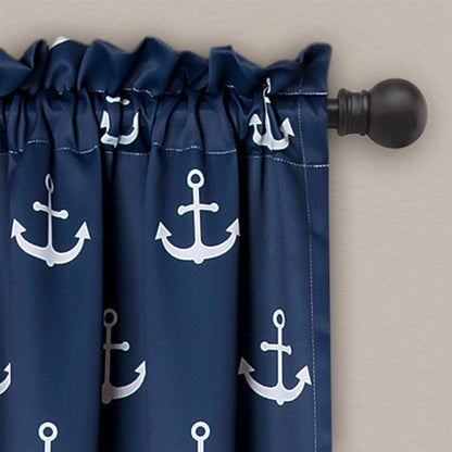 Navy blue curtains with white anchor patterns on a beige wall.