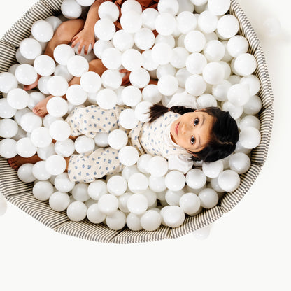 Children playing in a ball pit filled with white balls
