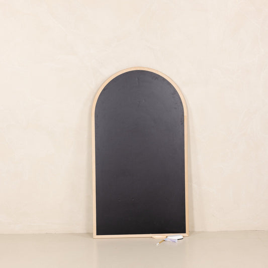 Arched blackboard with wooden frame on a beige background